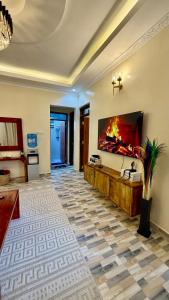 a living room with a fireplace on the wall at Serenity Elgon Stay in Eldoret