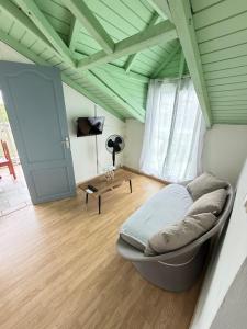a bedroom with a bed and a wooden floor at Le Naturel in Vidon