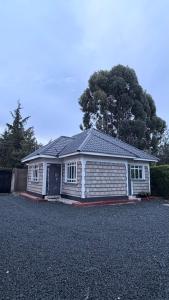 a small white house with a garage at Serenity Elgon Stay in Eldoret