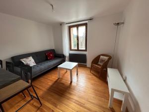 a living room with a couch and a table at Appartement Villars Colmars in Villars-Colmars +17 photos