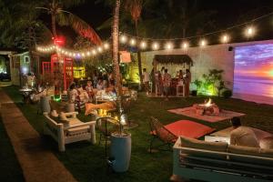 a group of people at a party in a yard at night at FlowHouse Jeri - Hotel & Coworking in Jericoacoara +100 photos