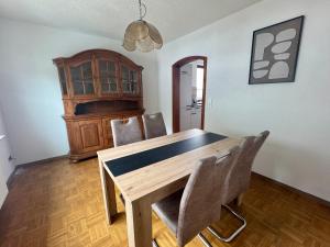 a dining room with a wooden table and chairs at Ferienhaus zum Wasserfall in Bernkastel-Kues