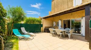 a patio with chairs and tables and a fence at Samaria Village N08 - 2P4 in Agde