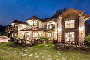 a large brick house with a yard at bonghwa solbaram pensyeon in Bonghwa