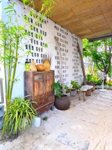 an outdoor area with a wooden cabinet and plants at Homestay Nhà Có Gió in Thôn Mỹ Tường +19 photos