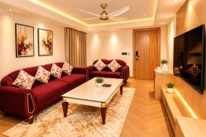 a living room with a red couch and a table at White Wharf Manesar in Gurgaon