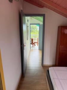 a room with a bed and a door leading to a patio at Le Naturel in Vidon