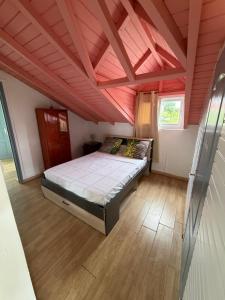 a bedroom with a large bed in a room at Le Naturel in Vidon
