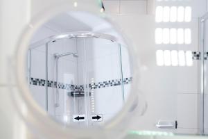 a bathroom with a shower and a mirror at Hotel Garni Ammergauer Hof in Oberammergau +58 photos
