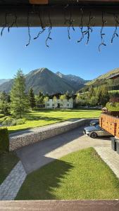 a view of a driveway with mountains in the background at Alpin Haus Berwang in Berwang