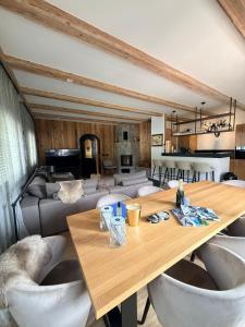 a living room with a wooden table and chairs at Alpin Haus Berwang in Berwang