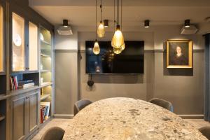 a dining room with a table and a painting at Hotel Skt. Annæ in Copenhagen