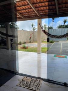 a view of a patio through a glass window at Casa vini in Viçosa do Ceará