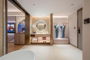 a dressing room with a mirror and a suit on display at Manxin Hotel Xian Bell Tower in Xi'an +60 photos