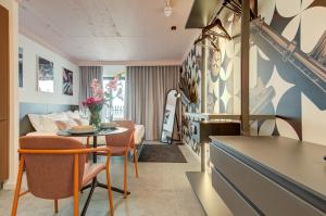 a living room with a couch and a table at Loft 23 Boutique Hotel in St. Julianʼs