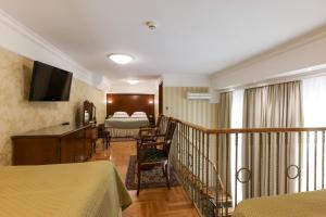 a hotel room with a bed and a balcony at Hotel Moskva in Belgrade