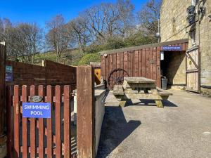 a wooden fence with a swinging pod sign on it at Ash Cottage - Ukc9266 in Hope