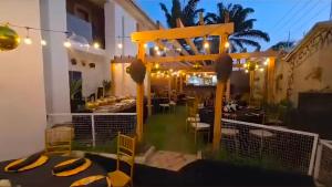 a view of the patio of a restaurant at night at Polo Signature Hotel in Kaduna