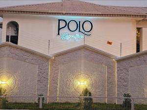 a pole sign on the side of a building at Polo Signature Hotel in Kaduna