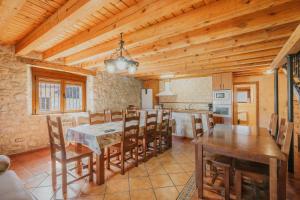 a kitchen and dining room with a table and chairs at Peña in Castro de Fuentidueña
