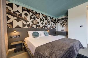 a bedroom with a large bed and a wall at Loft 23 Boutique Hotel in St. Julianʼs +78 photos