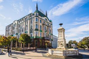 a large building with a statue in front of it at Hotel Moskva in Belgrade