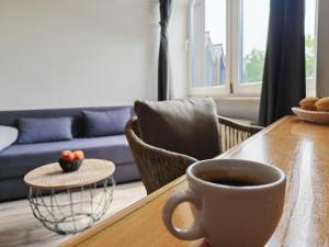 a cup of coffee on a table in a living room at Pure Hotel Dänischer Hof in Altenholz