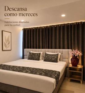 a bedroom with a large bed with black curtains at Aw Hotel Embassy Corner - Corferias, Embajada EEUU & Vive Claro in Bogotá +1 photo