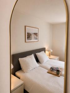 a bedroom with a bed and a mirror at Nice Nest Villa Hotels in Odense