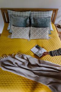 a person laying on a bed with a book at Agroturystyka Akacjowe Zacisze- pokoje ze śniadaniami, sauna, balia, tarasy wśród drzew, slow life in Stańkowa +214 photos