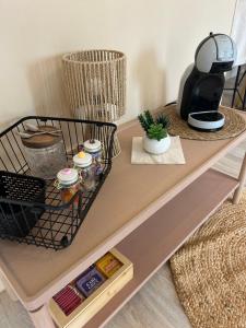 a table with a coffee maker on top of it at Le nid gourmand in Andryes