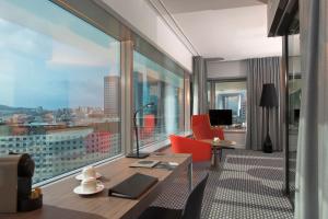 a hotel room with a view of a city at Meliá Paris La Défense in Courbevoie +106 photos