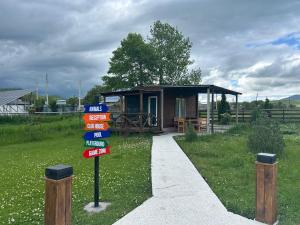a sign in front of a tiny house at V&V Hotel in Gyulagarak