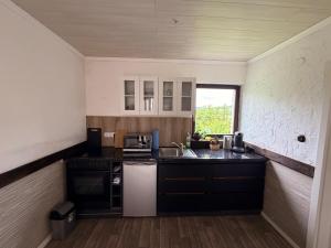 a small kitchen with a sink and a stove at Ferienwohnung Lebensbaum in Trimberg in Elfershausen