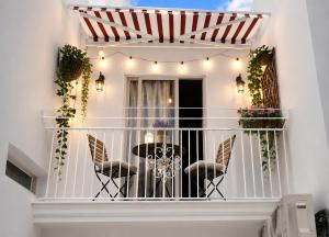 a balcony with a table and chairs on it at Affittacamere Silvagni in Caserta