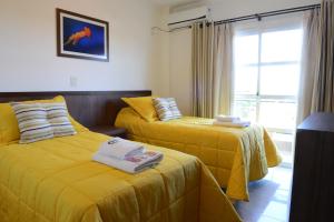 Postel nebo postele na pokoji v ubytování Ceferino Hotel