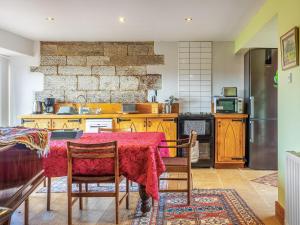 a kitchen with a table with a red table cloth at Seaton Court - Uk31955 in Staithes