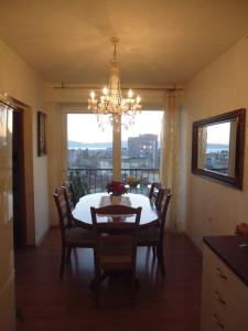 a dining room with a table and chairs and a chandelier at Apartment Sime in Zadar