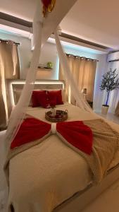 a bedroom with a canopy bed with red pillows at Private Oasis with Jacuzzi & Pool for Two in Ciales +46 photos