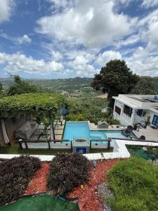a swimming pool in the backyard of a house at Private Oasis with Jacuzzi & Pool for Two in Ciales