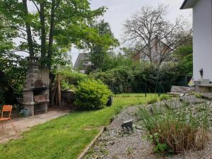 a backyard with a stone fireplace and a yard at La Tour de l'Ill in Strasbourg