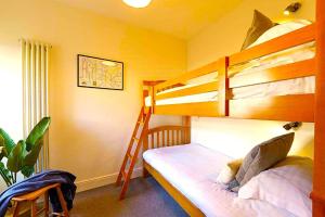 a bedroom with two bunk beds and a ladder at Premium Hotel EXO-Near Temple and Ghat#Parking and Comfort Stay#Premium Service in Varanasi