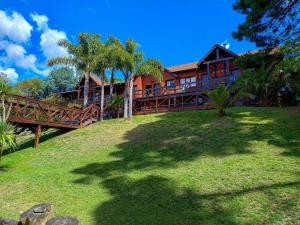 a large house on a hill with a green yard at San Remo Villa Corral Apart in Carilo