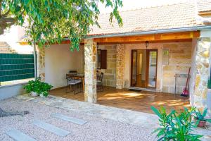 a porch of a house with a wooden deck at Nada Apartment near Krka National Park in Skradin