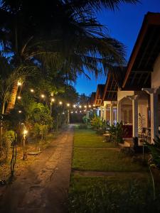 a row of houses at night with lights at Kuta Garden in Kuta Lombok