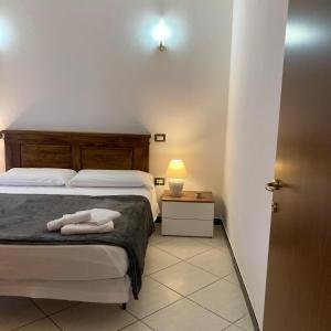 a bedroom with a bed and a table with a lamp at Casa Vacanza Margherita in Assemini