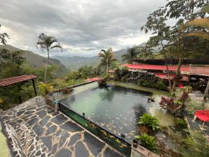 a large pool of water in front of a building at Payara Experience in La Vega