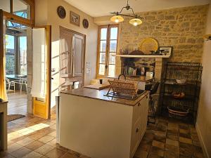 a kitchen with a island in a room at Ty Kabiten appartement VUE MER in Locmariaquer