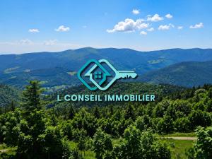 a logo for a company in the mountains at Gîte Arnica in Soultzeren
