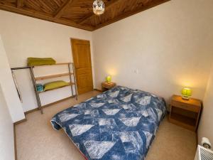 a bedroom with a bed and two lights on two tables at Gîte Arnica in Soultzeren